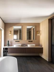 La salle de bains est pourvue de 2 lavabos et de 2 miroirs. dans l'établissement Terres Rouges, à Maussane-les-Alpilles
