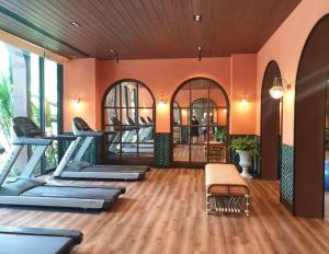 a gym with a row of treadmills and ellipticals at La Habana Hua Hin by Wilmot-200 m from the beach in Khao Tao