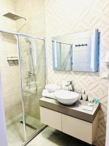 a bathroom with a sink and a shower at King David Residence in Tbilisi City