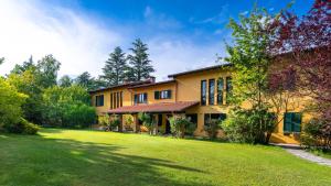 a large yellow house with a large yard at Tenuta Contessa Chiara 17, Emma Villas in Fontanile