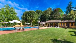 a backyard with a pool and a house at Tenuta Contessa Chiara 17, Emma Villas in Fontanile