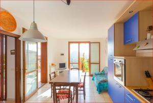 a kitchen and dining room with a table and chairs at La Loggia di Vanda - Goelba in Rio nellʼElba
