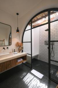 a bathroom with a shower and a sink and a mirror at Villa Lestari Ubud in Tegalalang