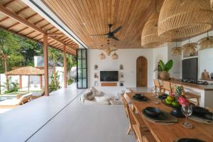 an open kitchen and living room with a wooden ceiling at Villa Lestari Ubud in Tegalalang