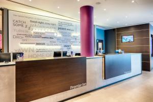 a lobby of a home office with a large wall with writing on it at Premier Inn Stuttgart Bad Cannstatt in Stuttgart