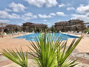 a large swimming pool with buildings in the background at Charming Studio in Sorrento Sole Mare in Sveti Vlas