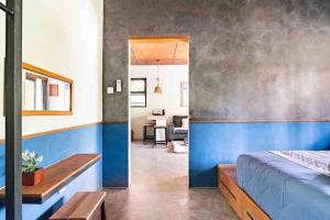 a bedroom with a blue and white wall at Relax in Nature Villa Namu Lombok in Kuta Lombok