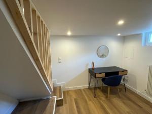 a room with a desk and a staircase with a mirror at Rouen maison de ville avec Jardin / Proche Quai de Seine / Proche Armada in Rouen