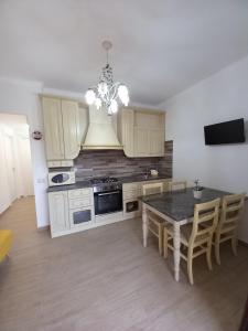 a kitchen with a table and a dining room at Casa vacanze M&M Tortolì in Tortolì