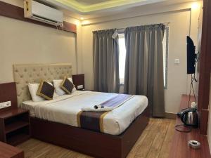 Ένα ή περισσότερα κρεβάτια σε δωμάτιο στο The Aster Enclave Hotel