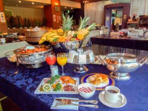a table topped with plates of food and drinks at Kai Resort Hotel in Fuefuki
