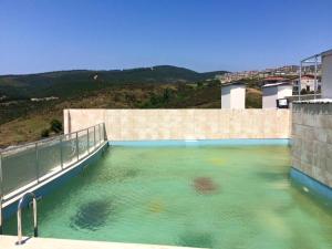 a swimming pool filled with water next to a building at AFAFET TERMAL in Yalova