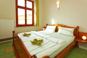 a bedroom with a large bed with flowers on it at Villa Maria Wohnung 08 in Ostseebad Koserow