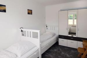 a bedroom with two bunk beds and a mirror at FeWo Pusteblume in Gollwitz