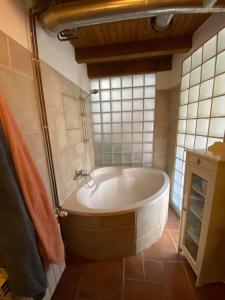 a bath tub in a bathroom with a window at Casa Tincana in Bebbio
