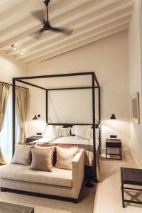 a bedroom with a large bed with a black frame at Sant Francesc Hotel Singular in Palma de Mallorca +25 photos
