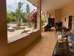 a kitchen and a living room with a patio at Casa Mariluka in Capoterra