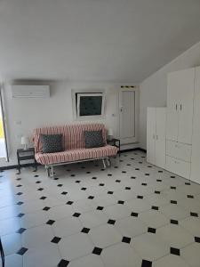 a living room with a couch and a checkered floor at La soffitta sul golfo in Lerici +14 photos