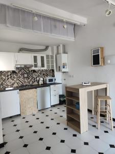 a kitchen with a counter and a table in it at La soffitta sul golfo in Lerici