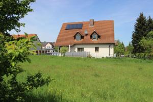 a house with a solar roof on a green field at Fränkische Seenliebe in Gunzenhausen