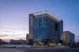 un edificio alto con molte finestre di 东莞凤岗众恒隆逸扉酒店 a Dongguan