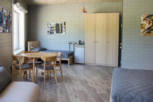 Zimmer mit einem Bett, einem Tisch und Stühlen in der Unterkunft Franciscan guest house in Klaipėda