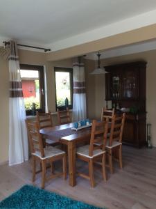 a dining room with a wooden table and chairs at Ferienapartment Kleist in Prerow