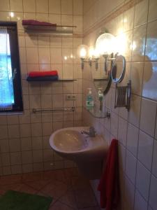 a bathroom with a sink and a mirror on the wall at Ferienapartment Kleist in Prerow