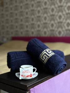 a cup of coffee and pillows on a table in a bedroom at LUZ @ Chisinau in Chişinău