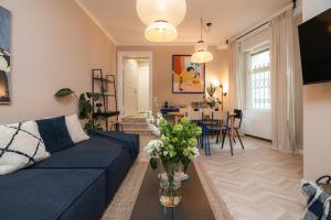 a living room with a couch and a dining room at Artsy Berlin Oasis Apartment by Arbio in Berlin