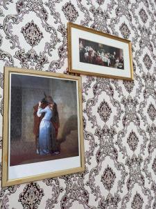 two framed pictures of a couple on a wall at LUZ @ Chisinau in Chişinău