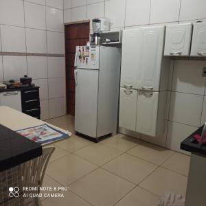 a kitchen with two white refrigerators in a room at Casa de temporada em Petrolina-pe in Petrolina