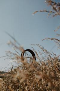 a field of tall grass with a sign in the background at Infinity at Enfin Estate in Nottingham Road