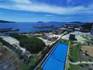 an aerial view of a resort with a swimming pool at Kota Kinabalu Jesselton Quay Sea View with washing machine in Kota Kinabalu