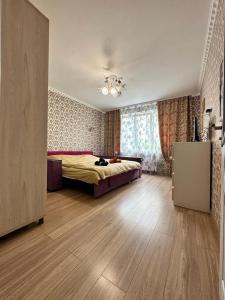 a bedroom with a bed and a dresser in it at LUZ @ Chisinau in Chişinău