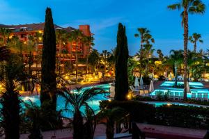 a view of the resort pool at night at Puerto Antilla Grand Hotel in Islantilla