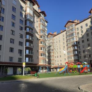 a playground in a city with tall buildings at LUZ @ Chisinau in Chişinău