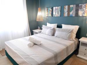a bedroom with a large bed with white sheets and pillows at Les Cerisiers The Cherry Trees in Flic-en-Flac +18 photos