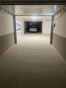 an empty garage with a car parked in it at Time to Be - Luxury Apartments Centro Storico in Peschiera del Garda