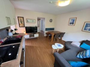 a living room with a couch and a table at Steerenklipp Kieker Bungalow 2 in Borkum