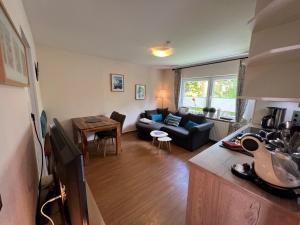 a living room with a couch and a table at Steerenklipp Kieker Bungalow 2 in Borkum