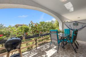 a patio with a bbq and chairs and a grill at Romeo&Julia- luxurious apartment by the sea in Pomer