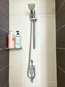 a shower with a shower head in a bathroom at Eco Kanvas Soho Suites in Cyberjaya