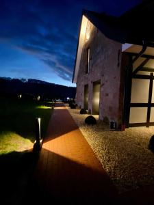 a night view of a building with a pathway at DRIEHOF Lifestyle Comfort Apartment 3 in Tecklenburg