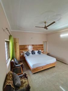 a bedroom with a large bed and a ceiling at Shakoon Camps & Farmstay Nainital in Nainital