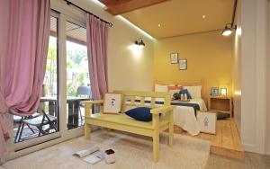 a childs bedroom with a bed and a balcony at Gyeongju Tiamo Pension in Gyeongju
