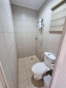 a small bathroom with a toilet and a shower at Grand Blue Beach Hotel in Boracay