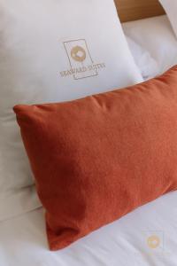 a brown pillow on a bed with a white box at Castelar Palace & SPA by Seaward Suites in Villajoyosa