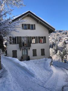 a house in the snow with a driveway at Residencecalou in Saint-Gervais-les-Bains