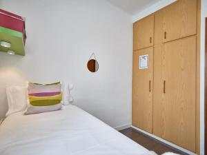 a small bedroom with a bed and a cabinet at Bed&BCN Arquimedes Barcelona in Barcelona